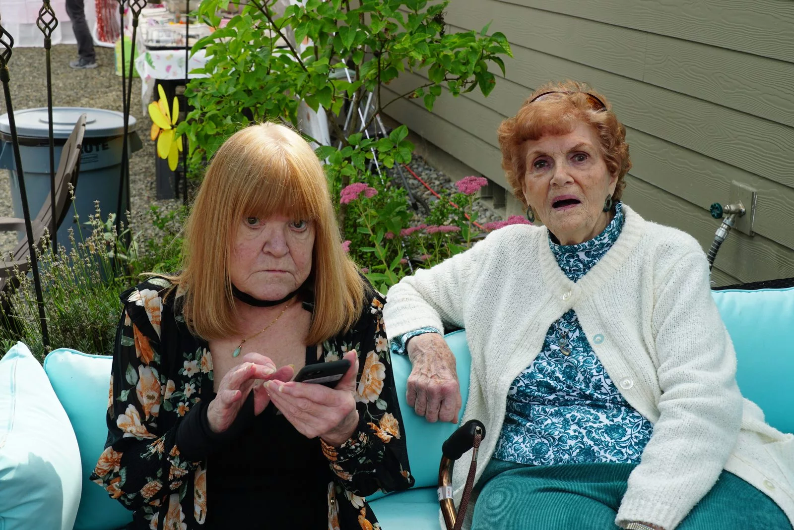 two women sitting outdoors
